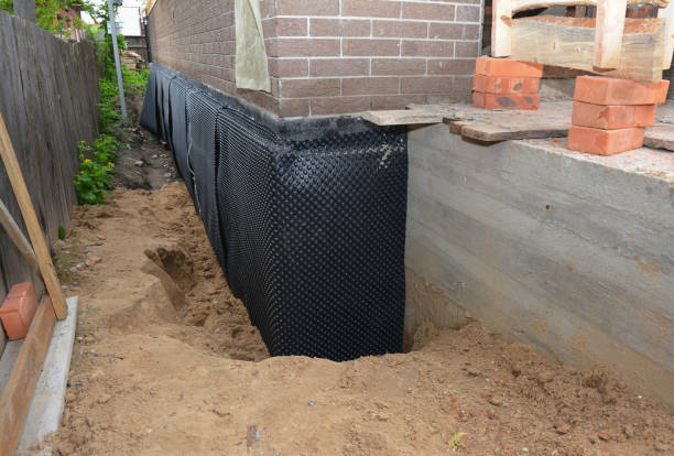 SJ Waterproofing Pros technician performing targeted Wet Basement Repair assessment in Freeport, NY